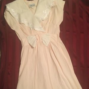 Pink dress with white collar trimmed in lace